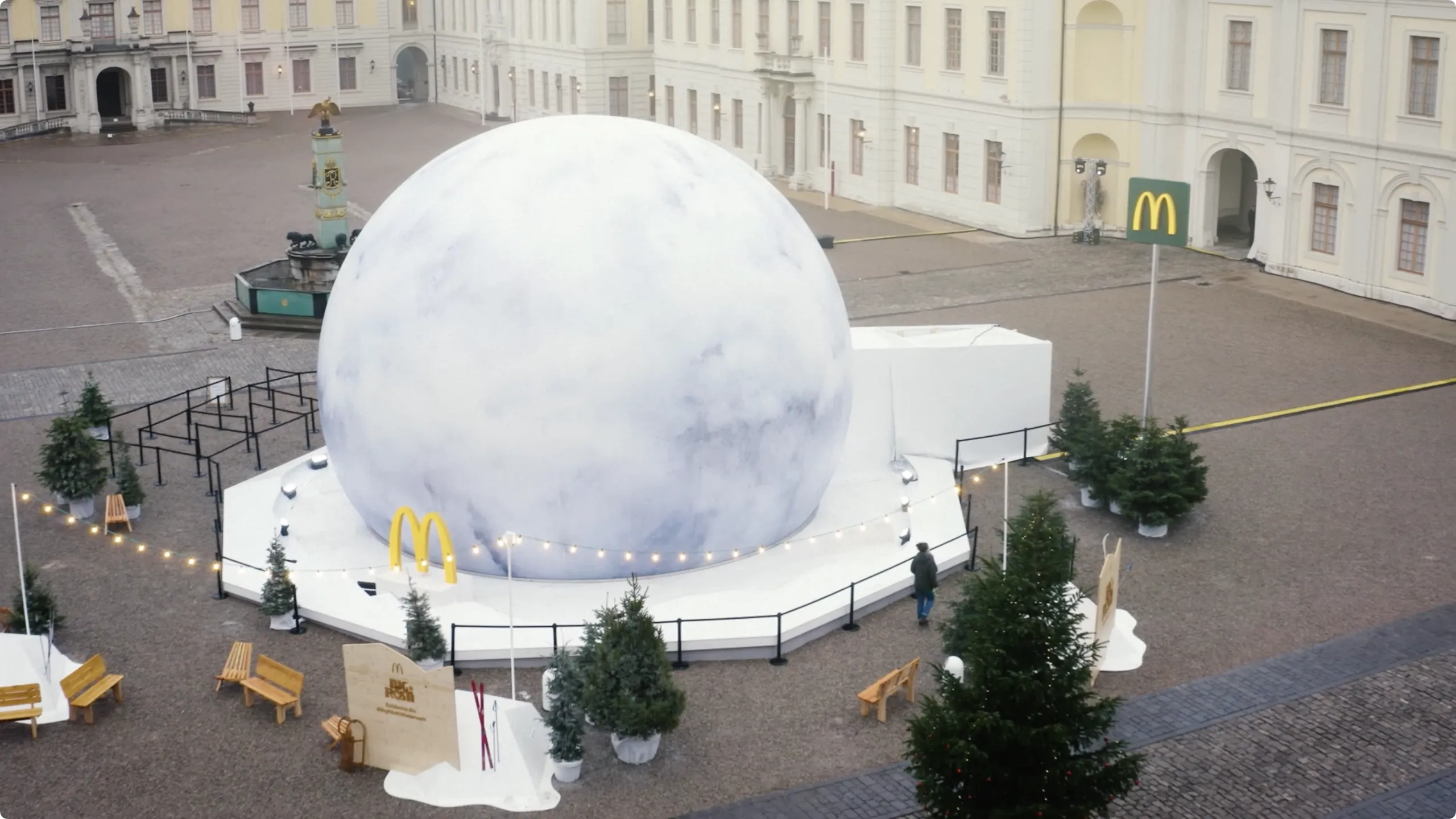Giant white sphere of the McDonald’s Wowball installation on a wintry palace square