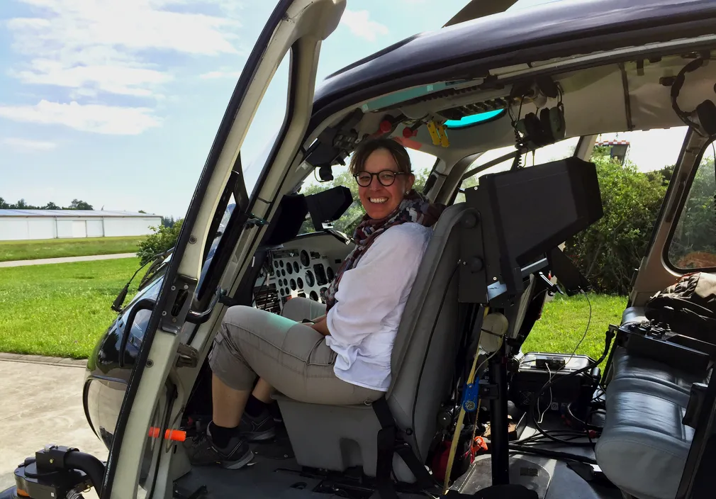 Crew member in a helicopter with camera gear for MAN intro movie aerials