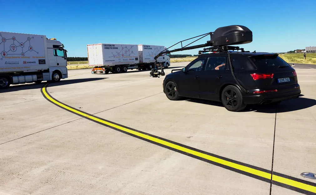 Camera car with crane arm filming trucks on an airfield for the MAN intro movie
